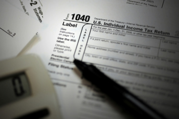 IRS 1040 form with pen and calculator