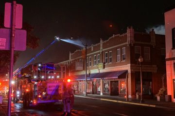 Fire engine on Main Street pouring water on a building.