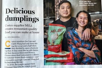 MìLà CEO Caleb Wang and president Jen Liao posing with a bag of MìLà pork soup dumplings.