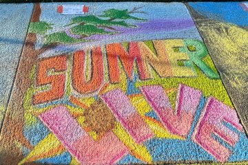 Chalk art on a sidewalk displaying the words 'SUMMER LIVE' in vibrant, blocky 3D lettering against a nature-themed background.